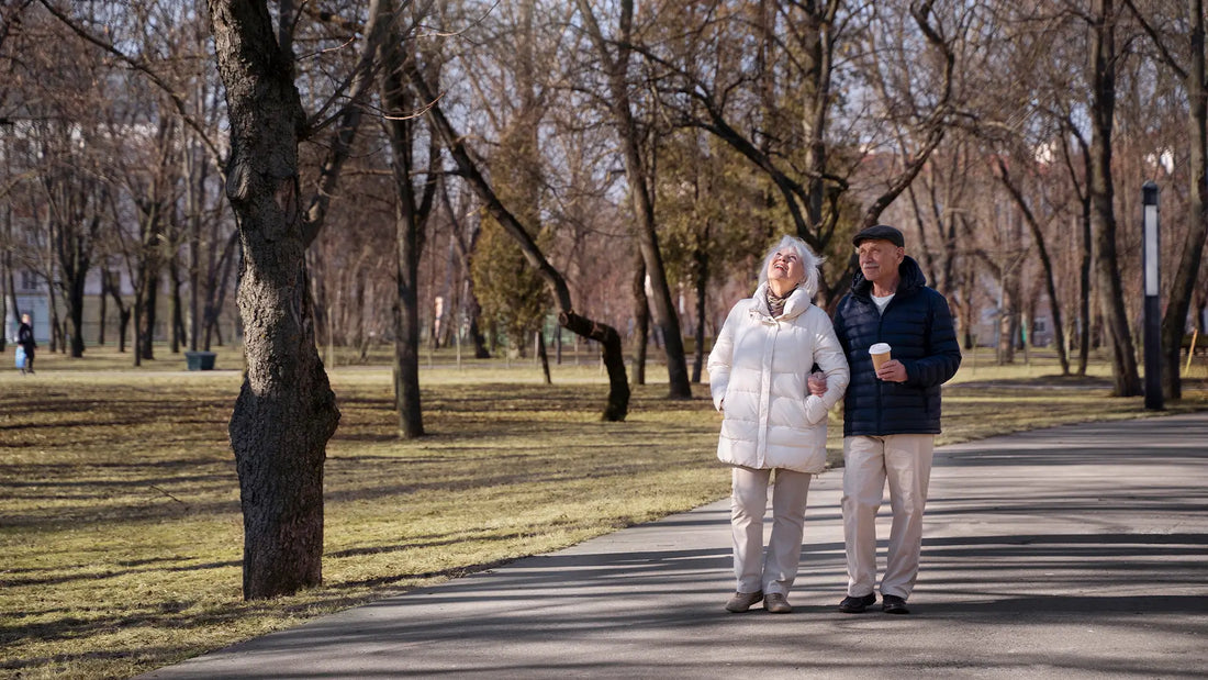 Elderly couple walking through park 